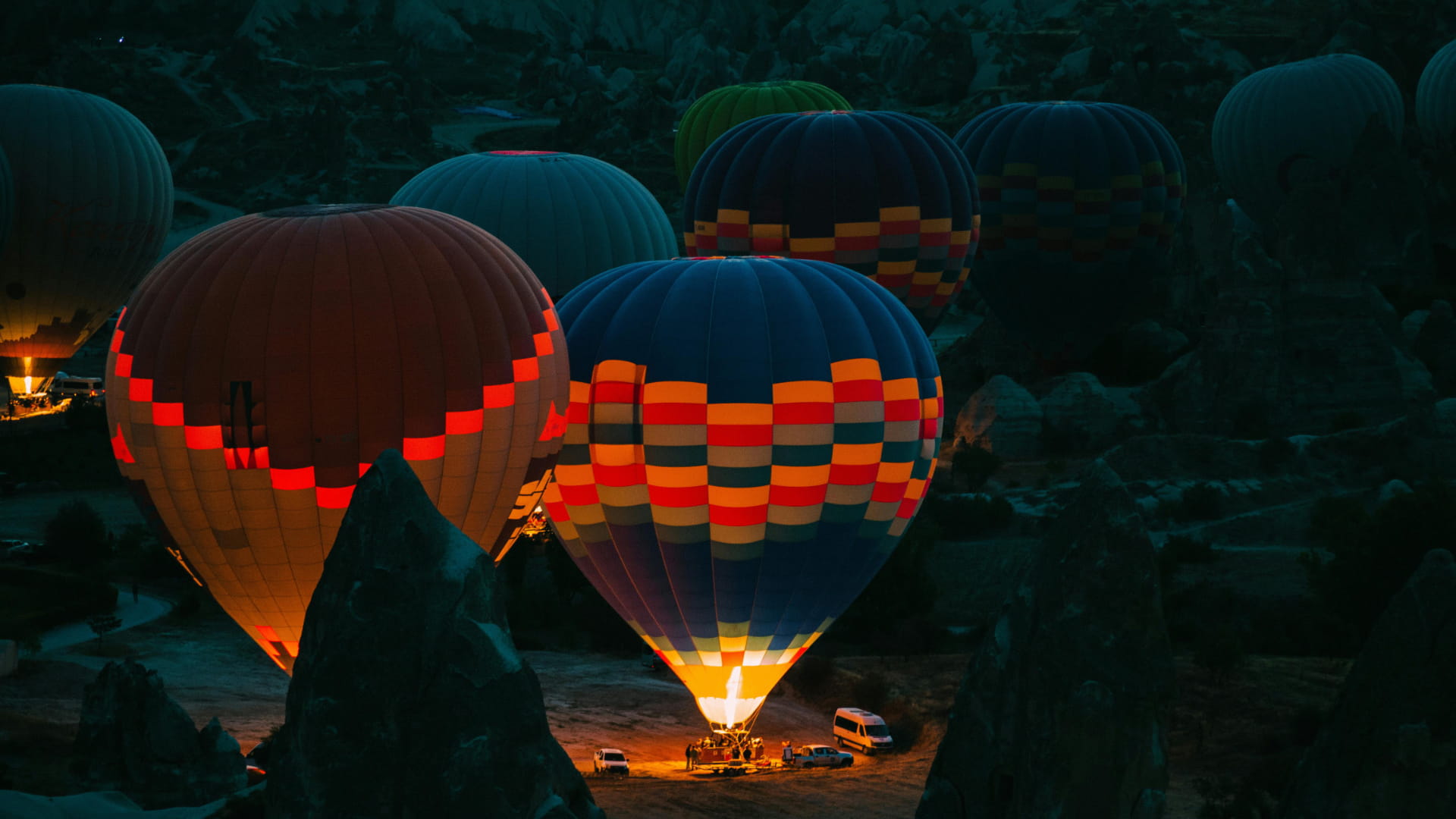 Night view of a hot-air balloon base camp.