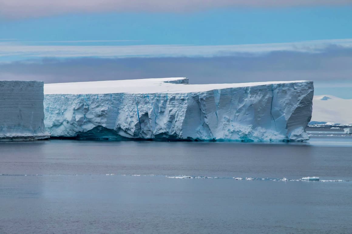 Stunning Antarctic landscape featuring massive icebergs and glacial formations in the sea.