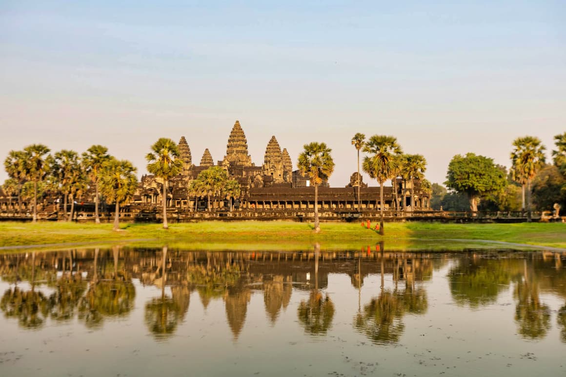 Iconic Angkor Wat stone temple architecture in Siem Reap, Cambodia, during golden hour.