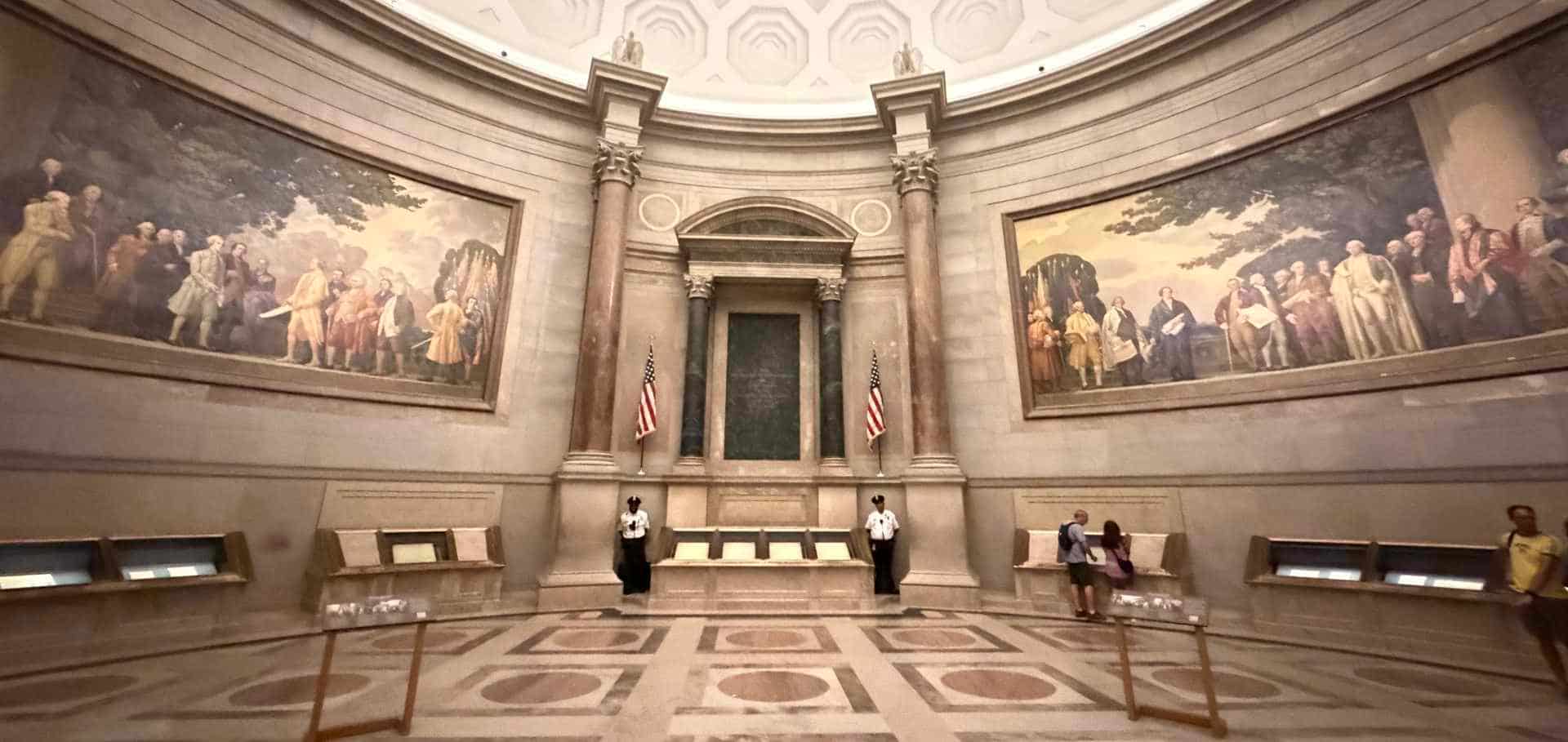 Grand vaulted rotunda and historical mural paintings inside the National Archives Museum in Washington D.C.
