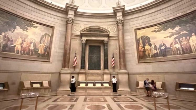 Grand vaulted rotunda and historical mural paintings inside the National Archives Museum in Washington D.C.