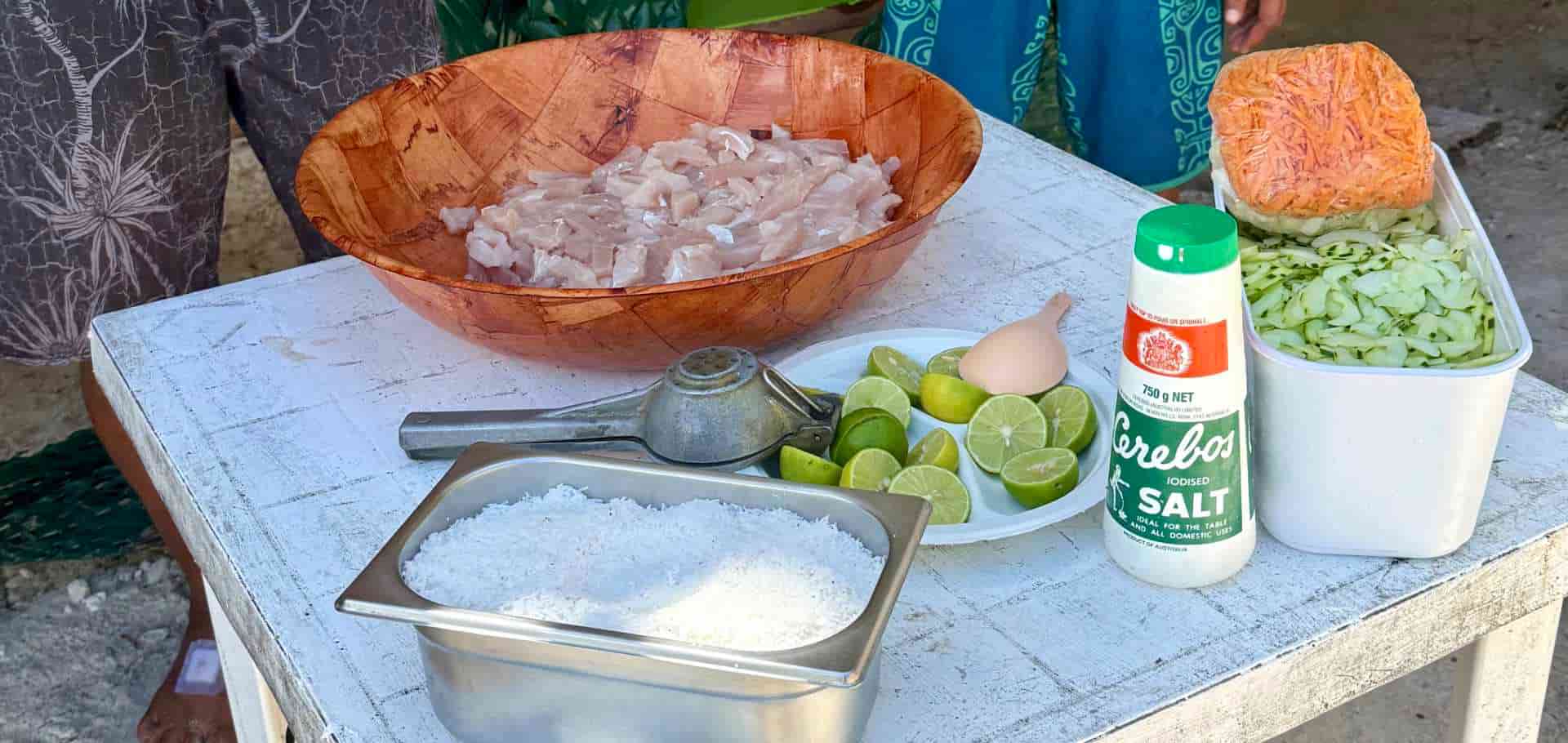 Local chef preparing traditional 'Ota 'Ika with fresh albacore tuna, salt, and limes on Huahine