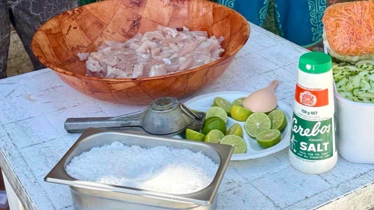 Local chef preparing traditional 'Ota 'Ika with fresh albacore tuna, salt, and limes on Huahine