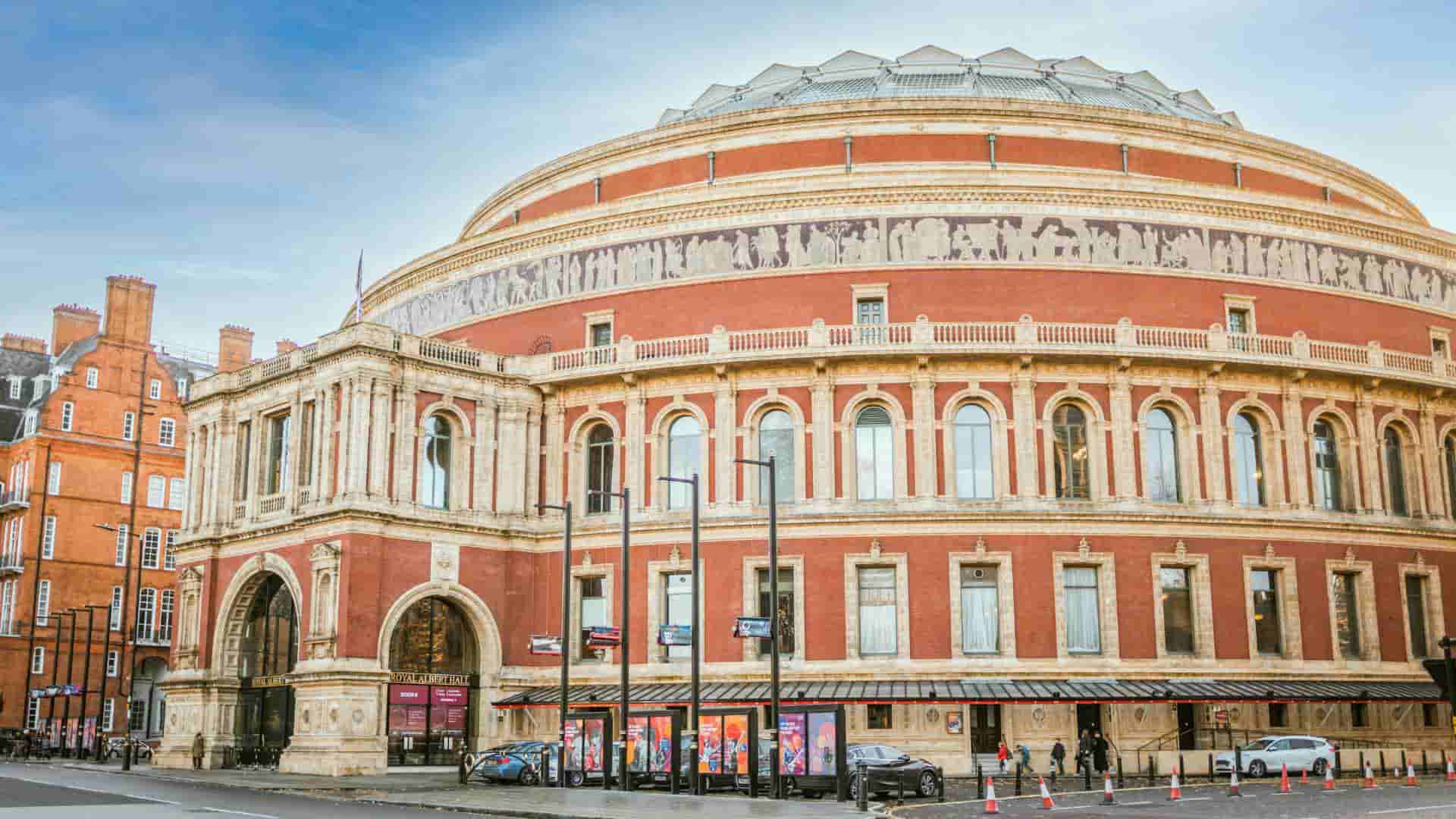 Expansive exterior view of the circular red-brick and terracotta architecture of the Royal Albert Hall