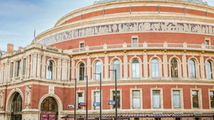 Expansive exterior view of the circular red-brick and terracotta architecture of the Royal Albert Hall