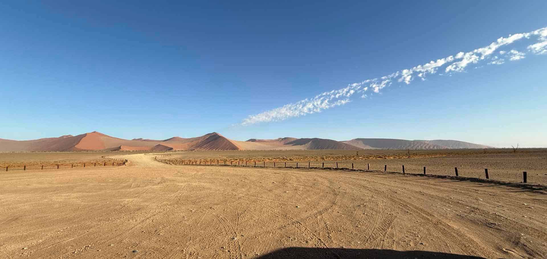 The paved valley corridor road leading toward the famous Namib desert dunes