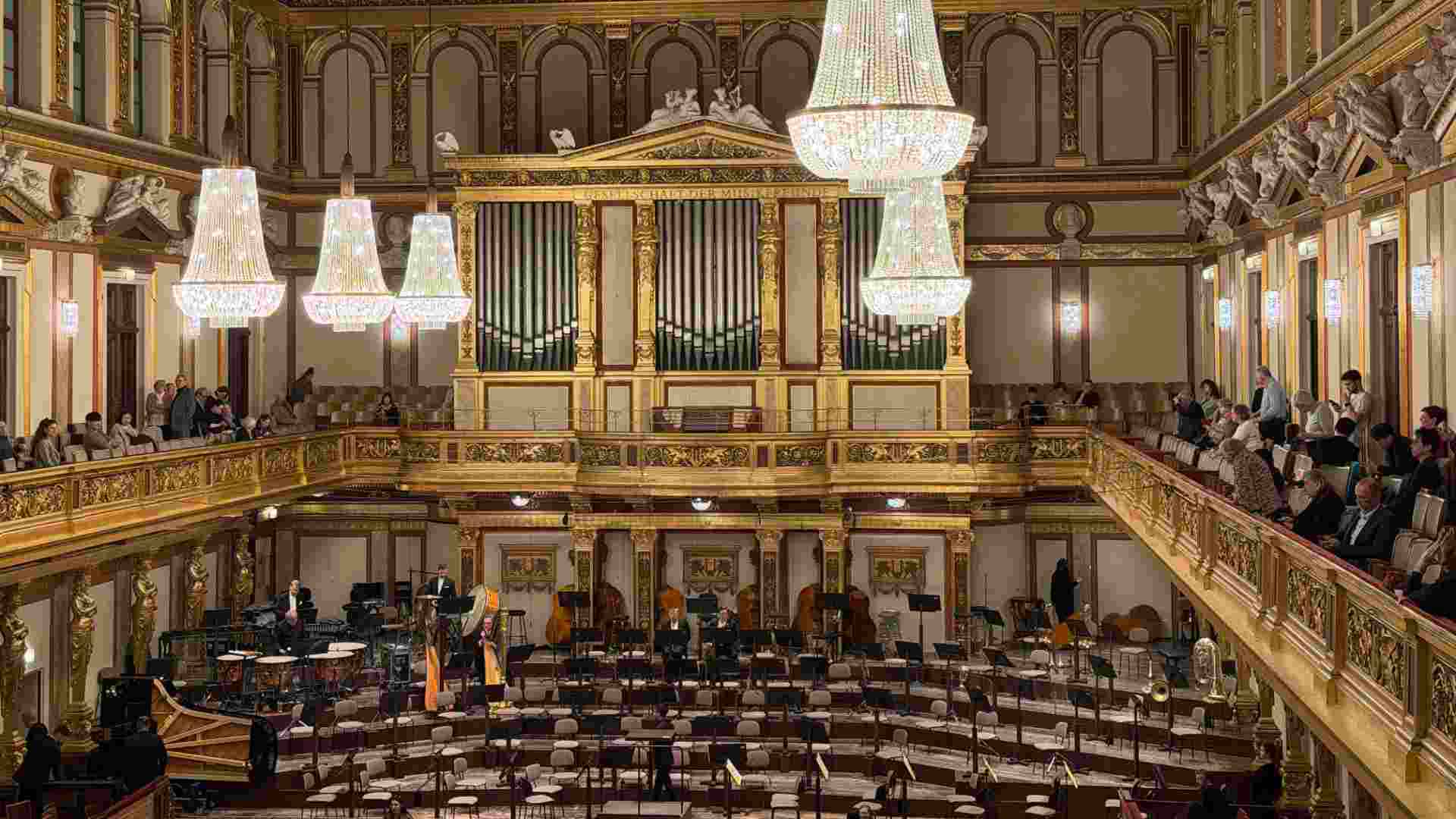 Grand pipe organ and glittering chandeliers adorn the majestic Golden Hall stage in Vienna.