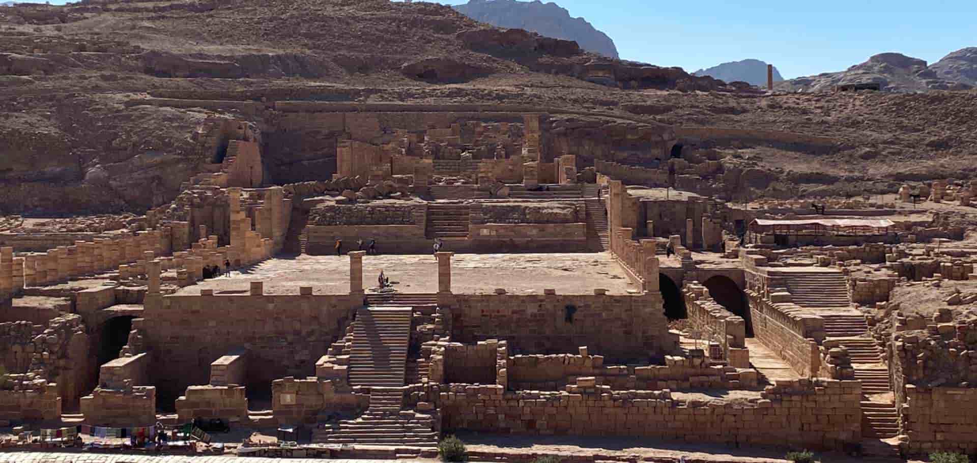 Expansive view of ancient stone steps and elevated architectural platforms carved into the rocky terrain.
