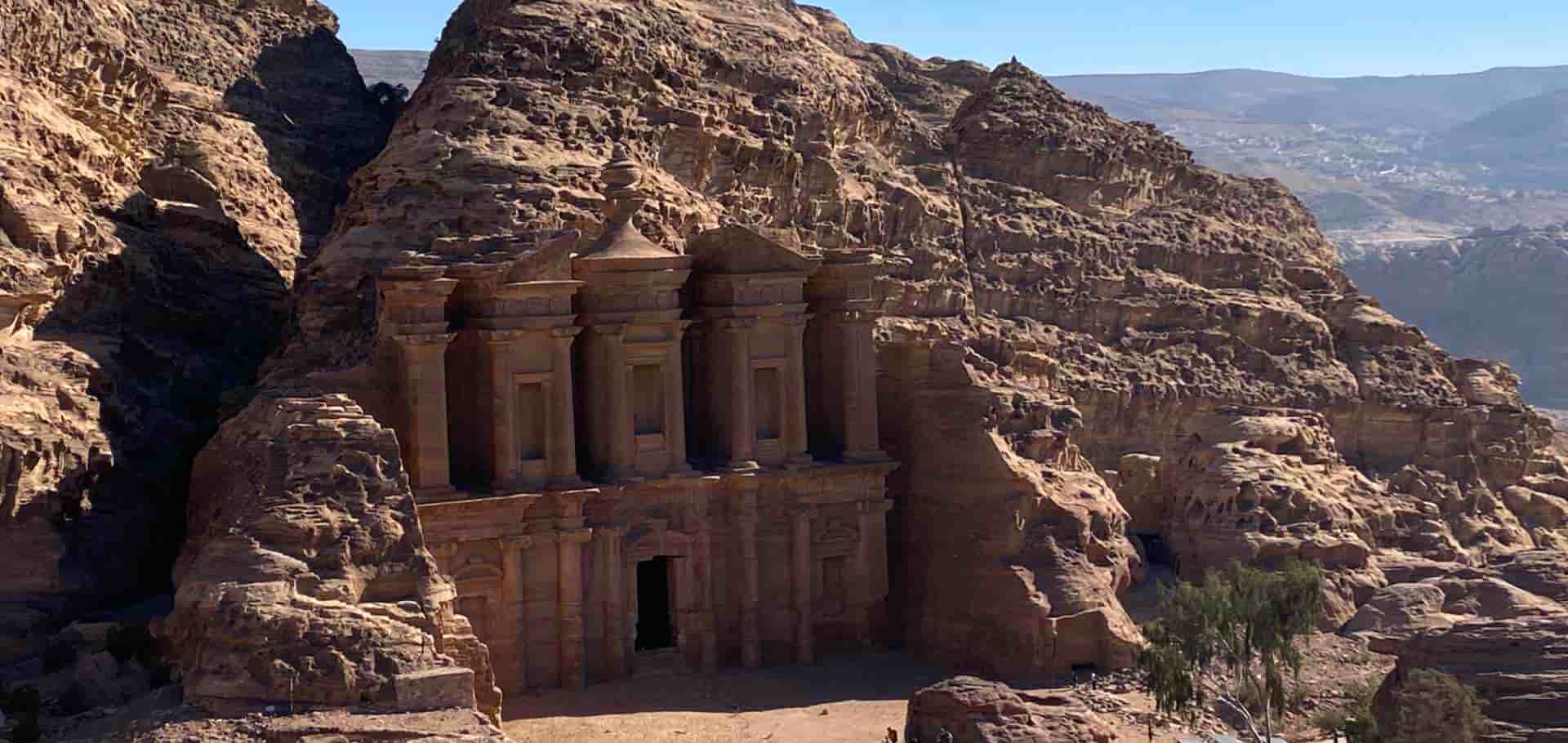The monumental stone facade of the Monastery carved into the high desert cliffs of Petra.