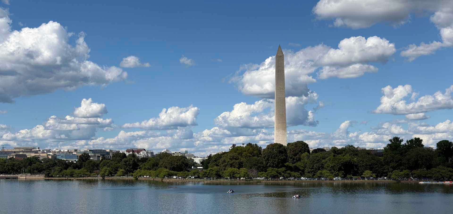 The towering Washington Monument reflecting across the water of the Tidal Basin.