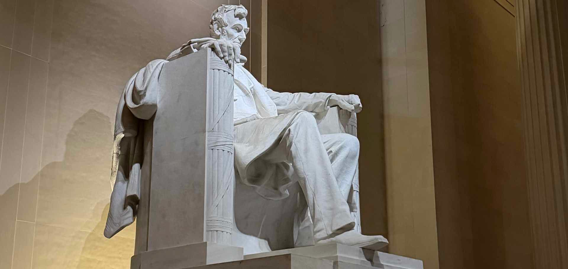 The imposing white marble statue of Abraham Lincoln seated inside the memorial chamber.