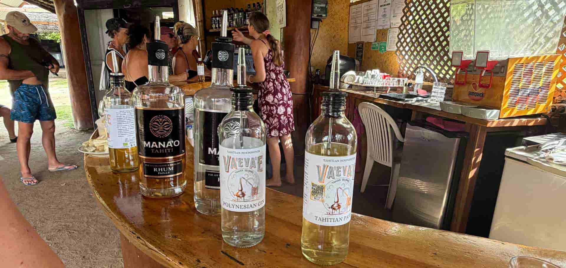 Wooden shelves stocked with bottles of artisanal rum and local spirits inside the tasting shop.