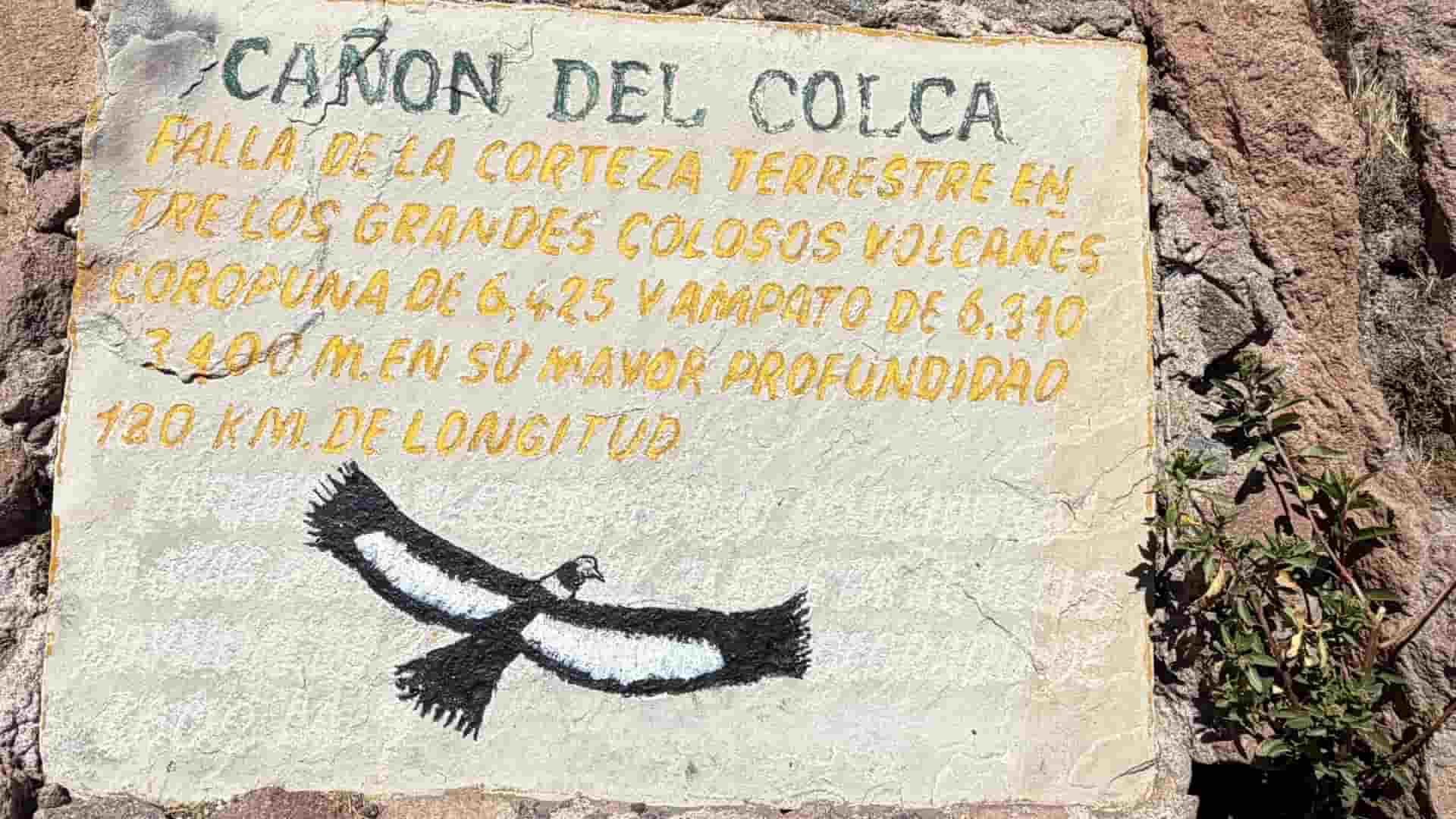 Painted stone sign detailing the depth and geography of Colca Canyon.