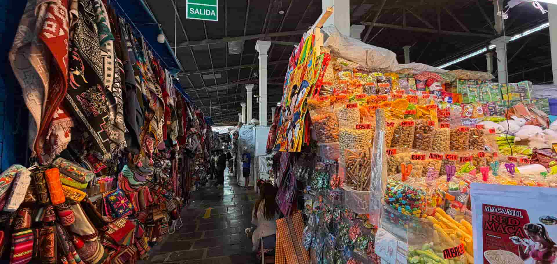 Colorful textiles and local food products displayed inside San Pedro Market.