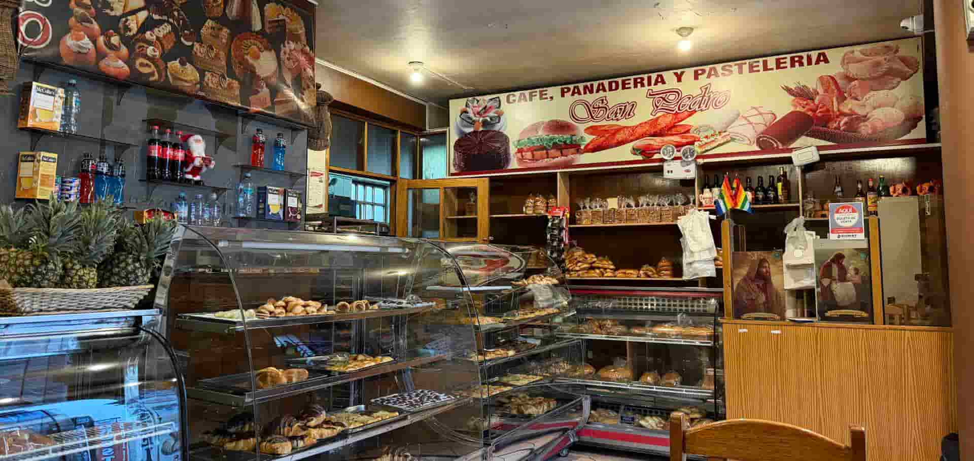 Display cases filled with fresh pastries and baked goods inside San Pedro Market bakery.