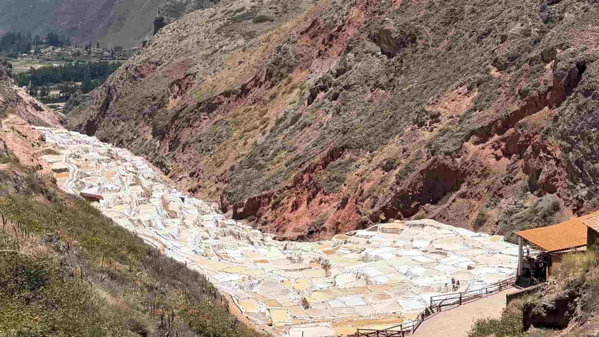 Wide-angle view of the deep canyon holding thousands of terraced salt ponds.