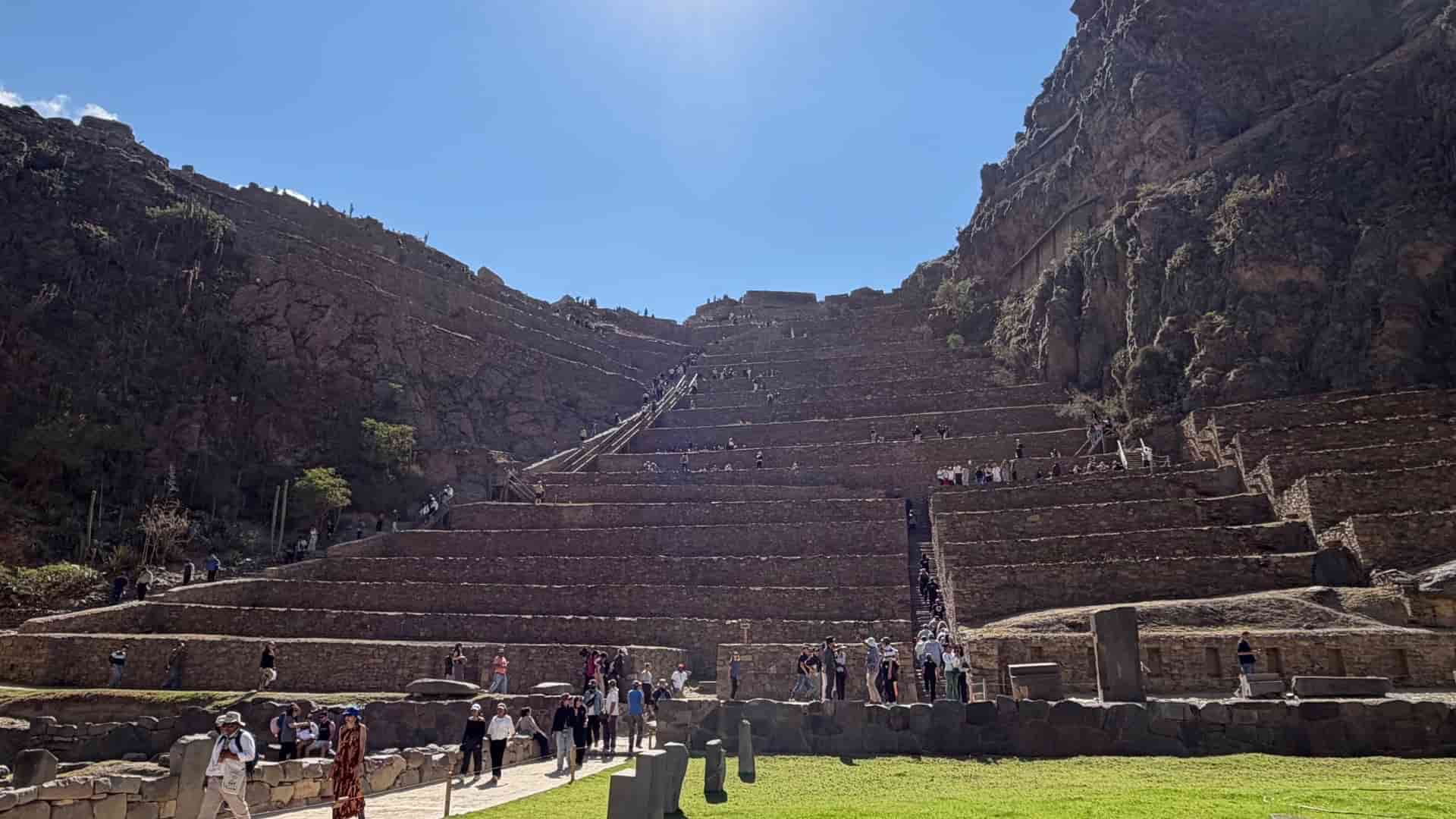 Massive monumental stone terraces rising steeply toward the mountaintop fortress.