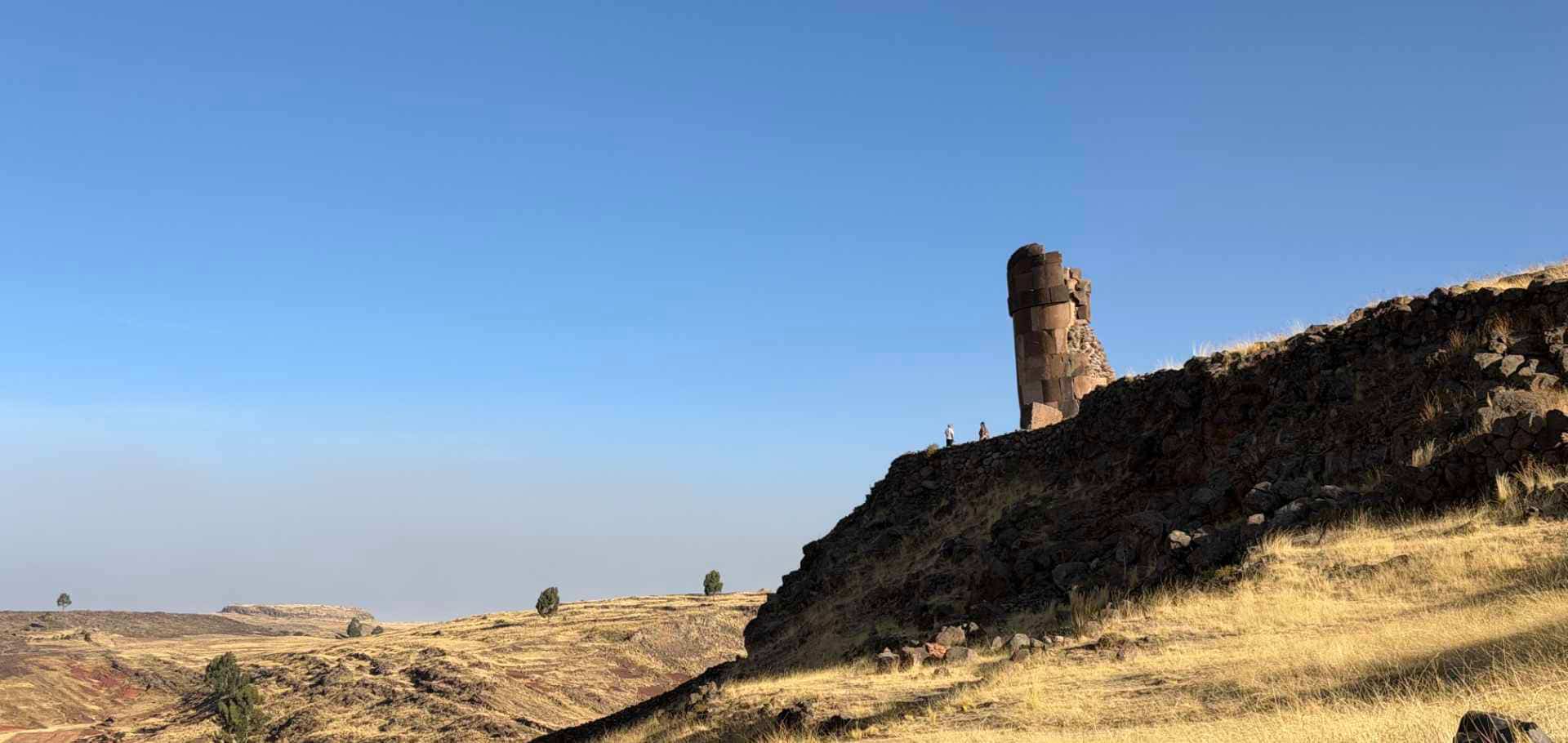 Close-up view of finely fitted stonework on an ancient cylindrical chullpa tower.
