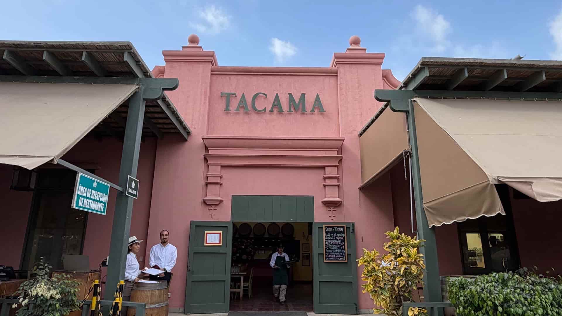 Pink colonial-style entrance facade and outdoor seating area at Viña Tacama winery.