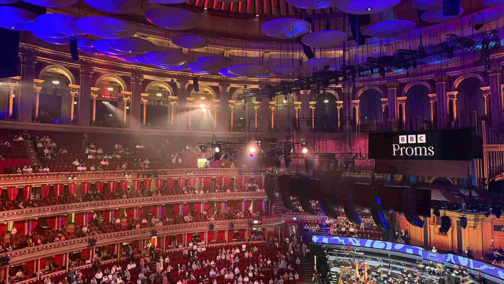Opulent interior view of the packed auditorium under the grand acoustic dome during a BBC Proms concert
