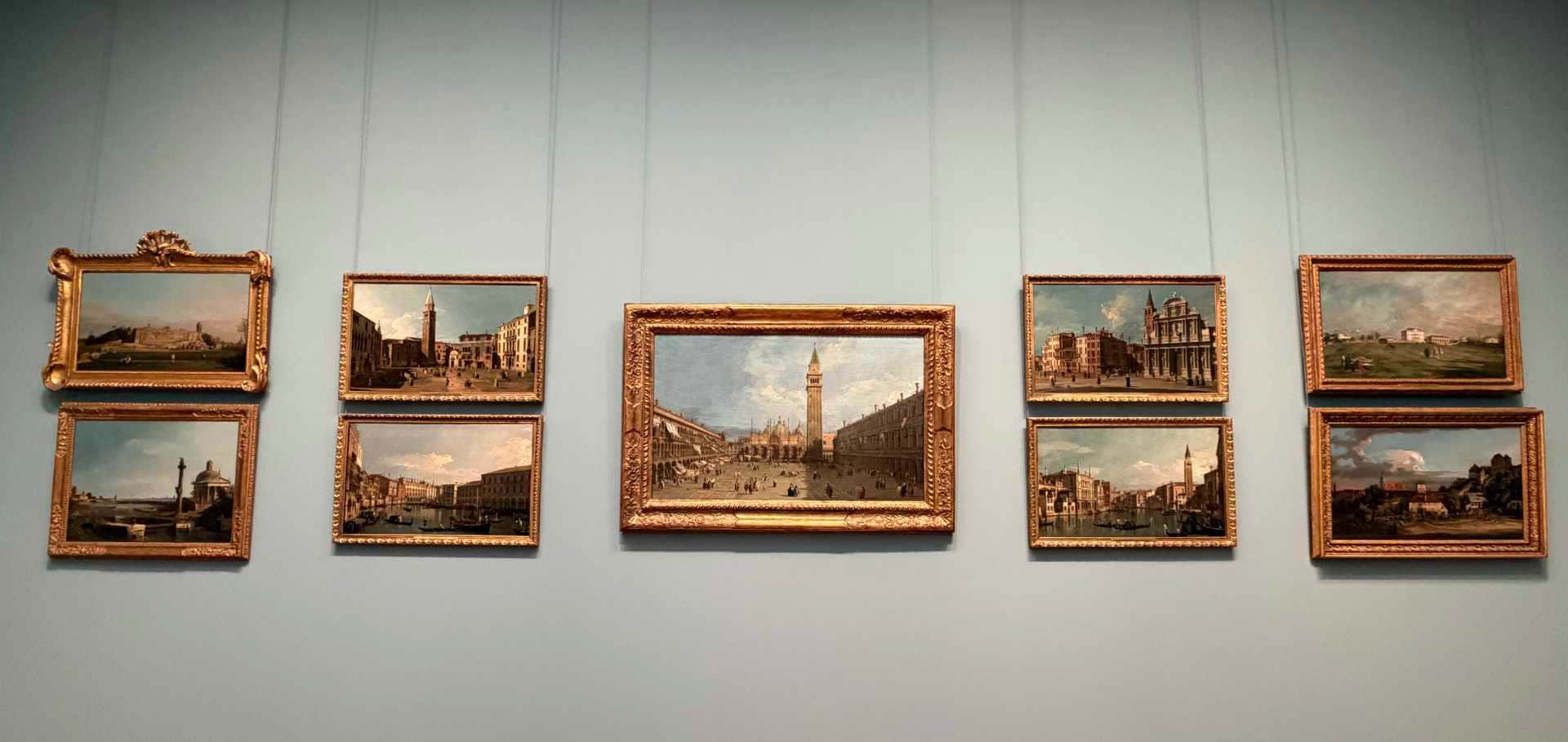Modernist paintings and a bronze sculpture displayed inside the bright exhibition galleries of the museum