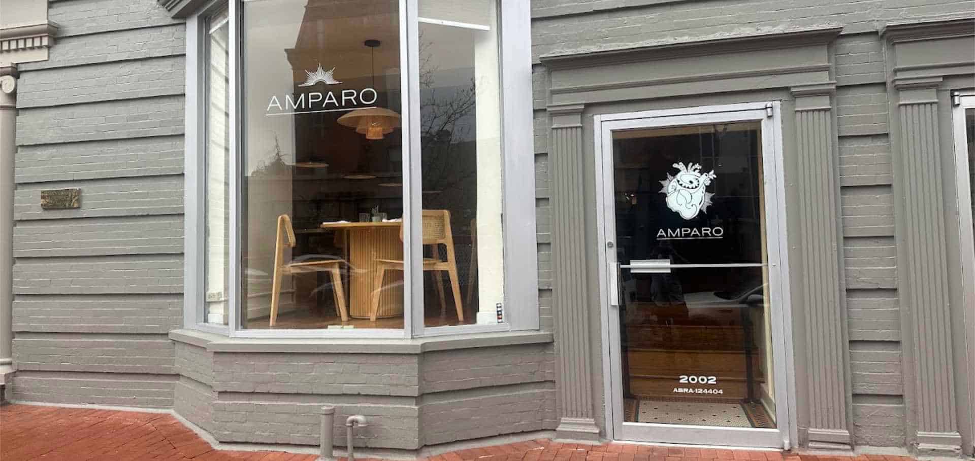 Gray brick exterior and glass storefront of Amparo Fondita in Dupont Circle.