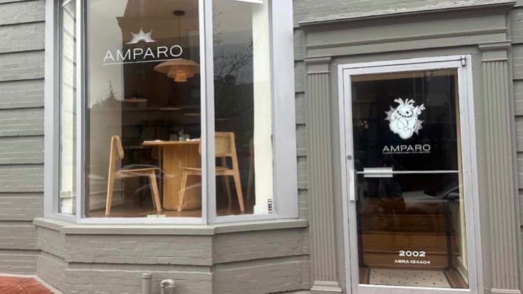 Gray brick exterior and glass storefront of Amparo Fondita in Dupont Circle.